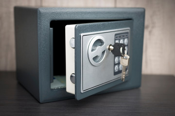 open safe with keys on the door on a light background - obrazy, fototapety, plakaty