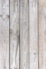 Wooden background. Boards in the sand. Wooden walkway on the sandy beach. Natural materials. The texture of the wooden surface. Beach landscape.