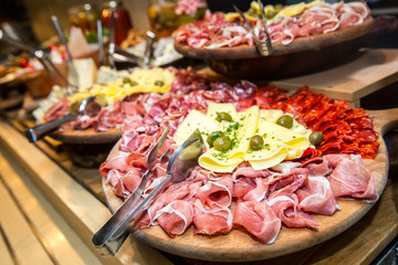 Appetizer. Wooden board with prosciutto, salami and cheese