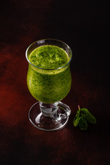 Ginger green apple smoothie on concrete background. It can be used as a background
