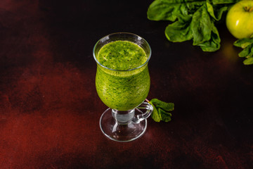 Ginger green apple smoothie on concrete background. It can be used as a background