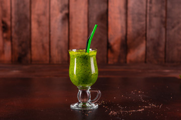 Ginger green apple smoothie on concrete background. It can be used as a background