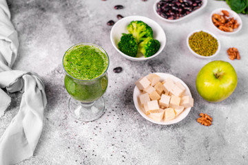 Ginger green apple smoothie on concrete background. It can be used as a background