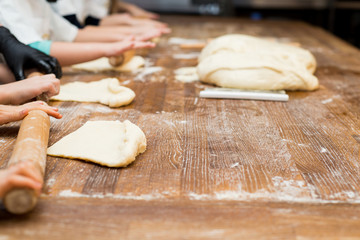 Young children make hot dog. Hands closeup
