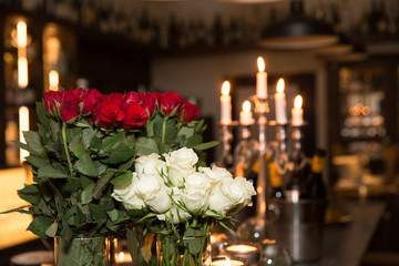 Bouquet of white and red roses in a vase and candlestick