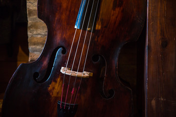 Vintage contrabass on wooden floor © fotosr52