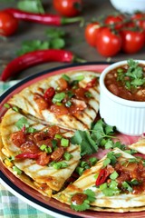 Quesadilla grill with spicy salsa with chili pepper. Mexican traditional food, wheat tortillas. 
