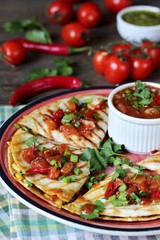 Quesadilla grill with spicy salsa with chili pepper. Mexican traditional food, wheat tortillas. 