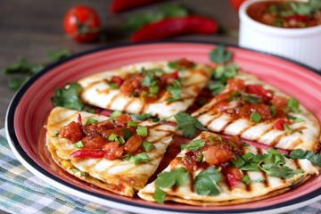 Quesadilla grill with spicy salsa with chili pepper. Mexican traditional food, wheat tortillas. 
