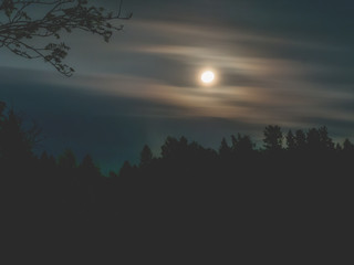 Moon in the night sky and moving clouds. long exposure shot