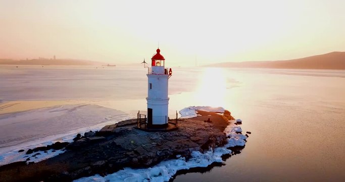 Top aerial panoramic view of Tokarev Lighthouse in Vladivostok. The lighthouse is located in the Peter the Great Bay of the Golden Horn. One of the oldest lighthouses of the Far East.	