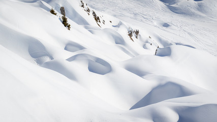 Rocks covered by pristine snow in mountains