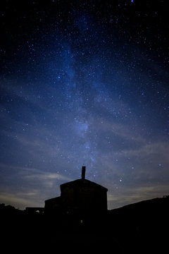 Milky way comming from Eunate church in a cloudy night near Pamplona, Spain