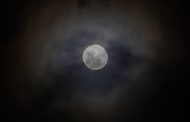 Naklejka na ściany i meble Full moon, with clouds passing over