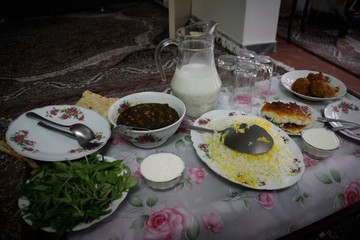 Traditional Iranian homemade food: beans, rice, greens and sour milk