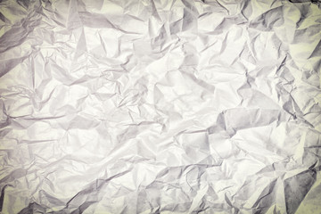 Texture of crumpled paper, background. Photo with vignette.