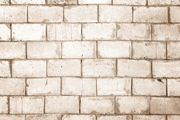 Light brown wall made of large bricks. Background with brickwork texture.