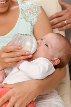 Closeup photo of newborn baby with feeding bottle