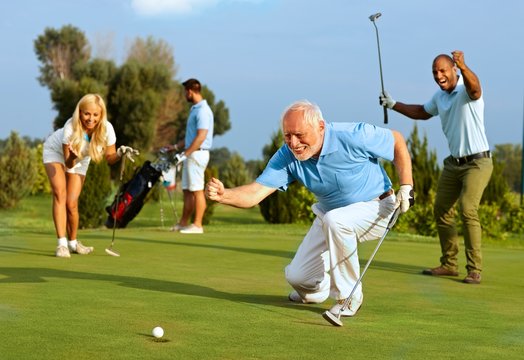 Senior golfer putting