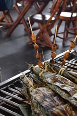 Grilled weevil larvae with banana leaf pouches