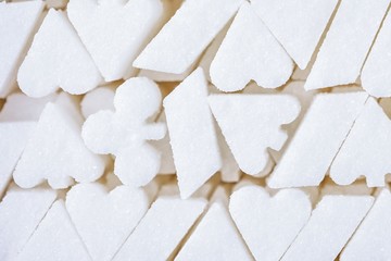White sugar background. Shape of the playing card suit symbol. Addiction of sweets like a gambling addiction.
