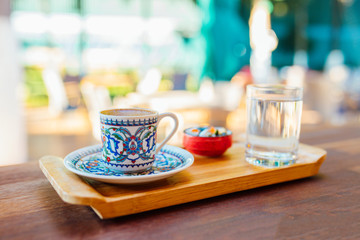 Traditional delicious turkish coffee on wooden table in cafe or restaurant
