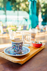 Traditional delicious turkish coffee on wooden table in cafe or restaurant