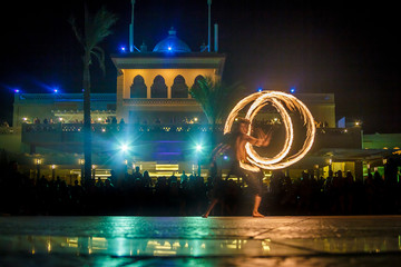 Night performance fire show in front of a crowd of people on the street in night Egypt, palace and...