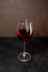 Fotobehang wine glass with red wine on a stone background © александр таланцев