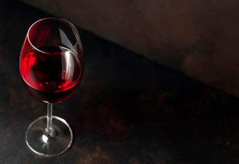 Glasses with red wine and a bottle on a stone background. View from above
