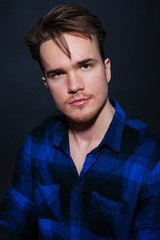 Studio portrait of young man on a dark background