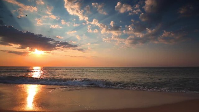 Ocean beach sunrise with sky, fluffy clouds and sun rays, video