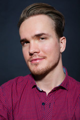 Studio portrait of young man on a dark background