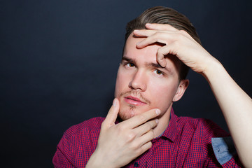 Studio portrait of young man on a dark background