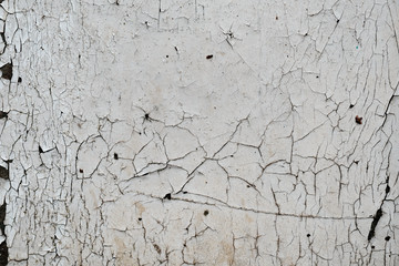 Texture of cracked paint on a wall, black and white grunge urban background, distressed overlay