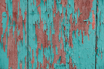 cracked vertical wooden panel with peeling green paint, textured surface background