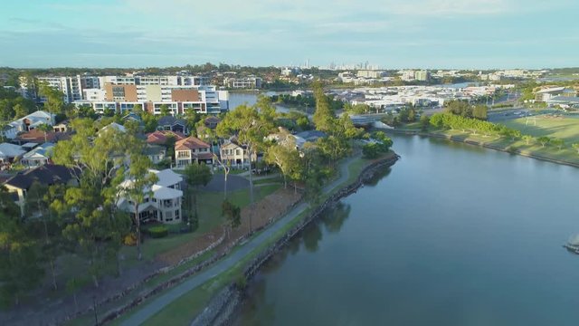 Slow rise over luxury homes at Varsity Lakes suburb at sunset. Gold Coast, Queensland, Australia