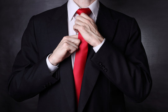 Businessman fixing his tie knot