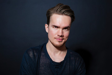 Studio portrait of a young man on a dark background
