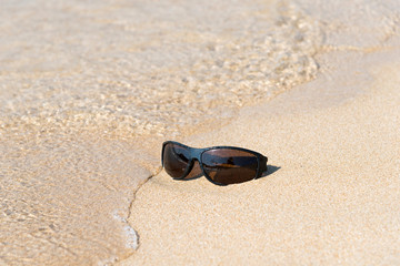 Fototapeta na wymiar Sunglass in the sand