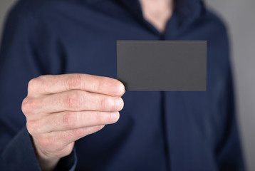 A man holding black business card