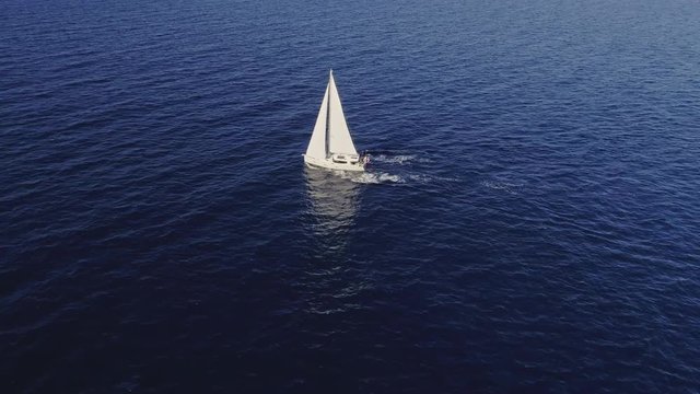 Drifting sailboat on open waters