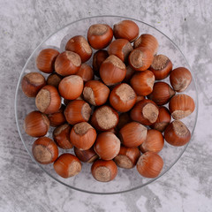 Nuts. Heap of hazelnuts on a plate. Top view. Close-up. Food photography.