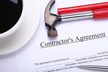 Contractor's agreement next to a cup of coffee
