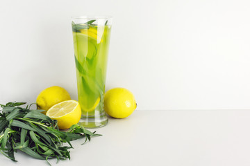 Tarragon drink with lemon on gray background. Copy space. Home made refreshing  lemonade.