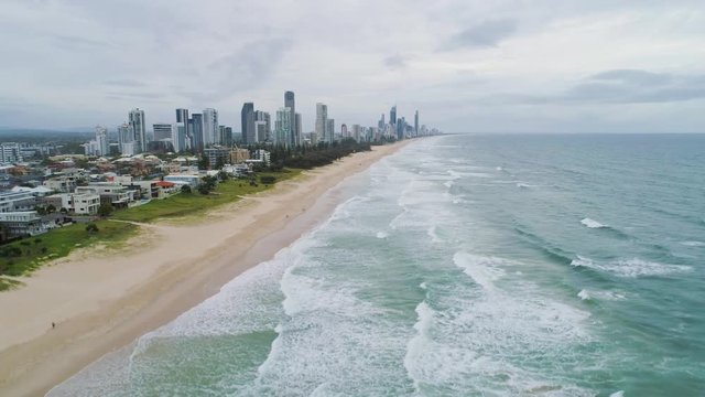 Slow rise over Mermaid Beach facing Gold Coast high rise buildings in Queensland, Australia