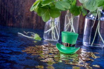Saint Patrick's Day green leprechaun hat on gold shamrocks