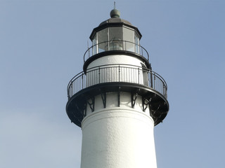 Active St Simons Georgia Lighthouse Top. The St Simons Lighthouse on the barrier island of St. Simons, Georgia, was completed in 1872, and still guides mariners into the sound and channel.