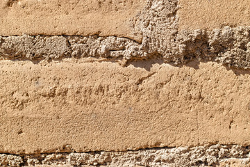 old stone wall of brick and mud