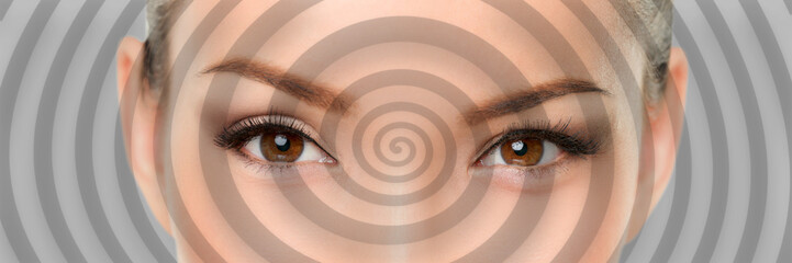 Hypnosis spiral over eyes of woman hypnotized closeup banner panorama. Asian girl portrait background. - obrazy, fototapety, plakaty